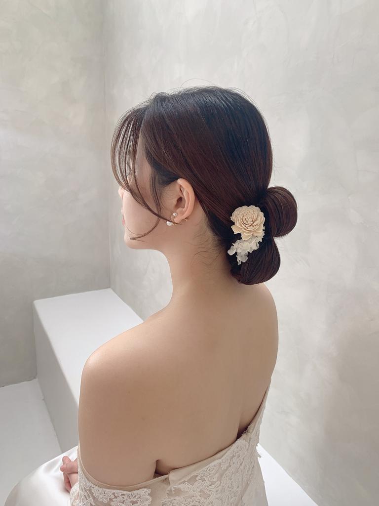 Elegant bridal hairstyle with floral accessory