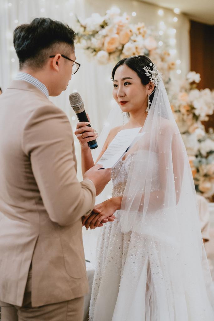 A beautiful wedding ceremony in Singapore, featuring elegant decorations and a joyful couple exchanging vows.