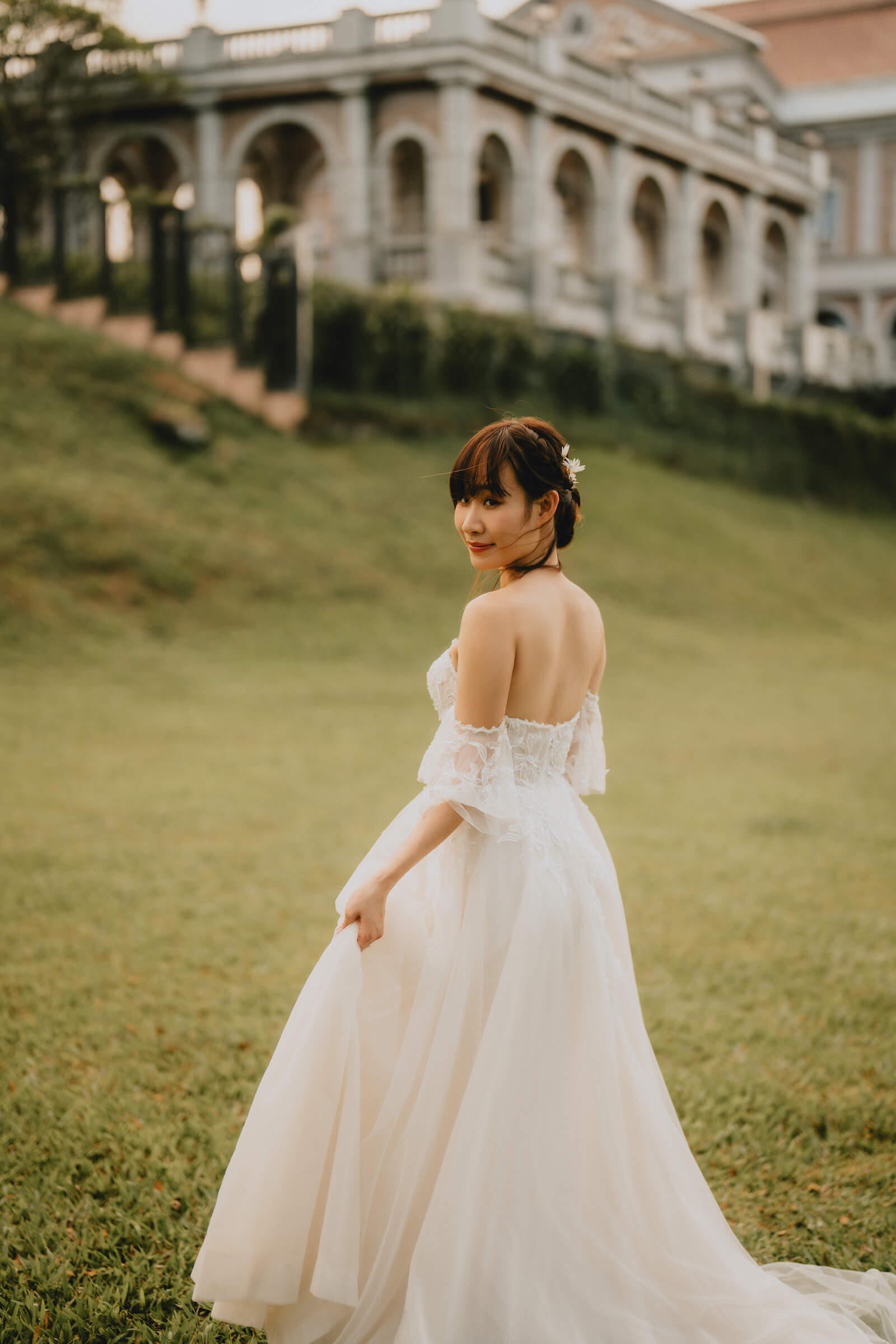 A beautiful wedding dress elegantly displayed by a serene lake, surrounded by nature's tranquility and soft reflections.