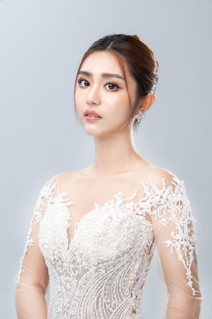 Beautiful Asian woman wearing an elegant white wedding dress, radiating joy and grace on her special day.