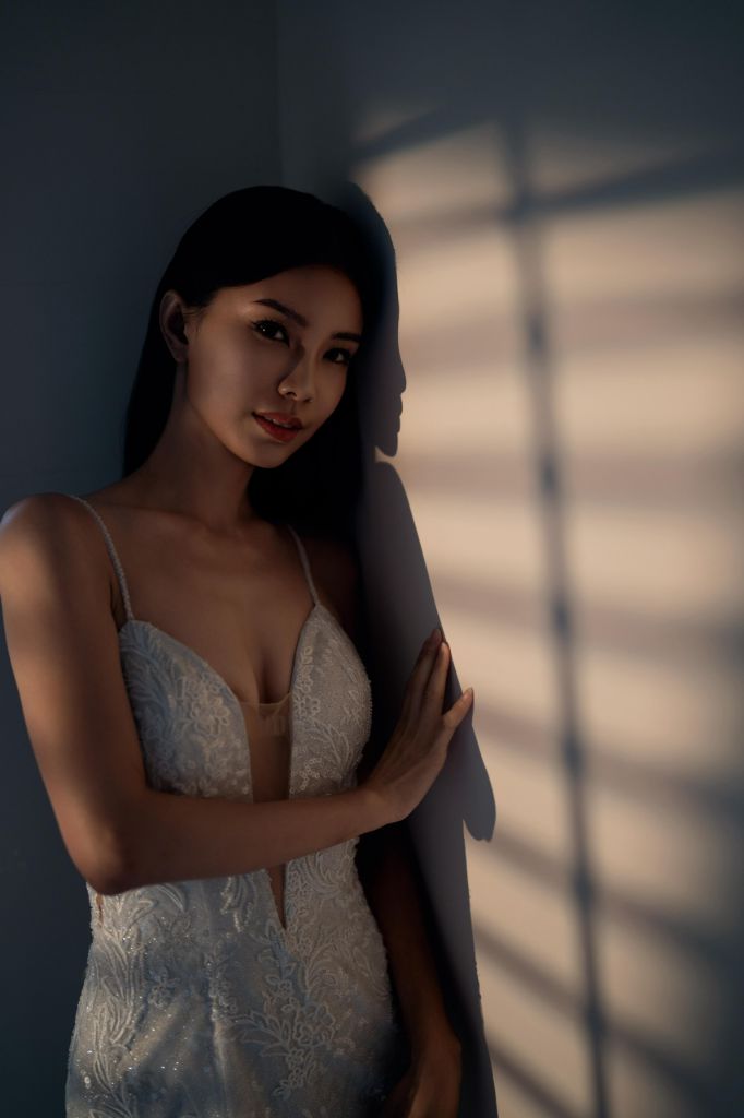Bridal portrait in soft window light with lace gown