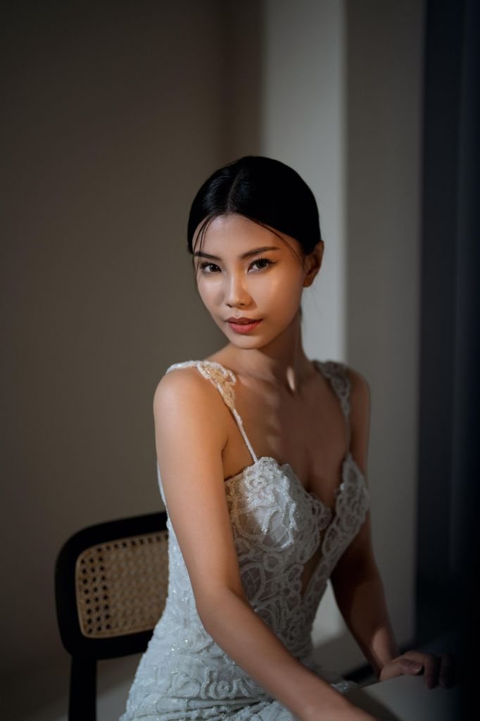 Bridal portrait by a window with soft natural makeup