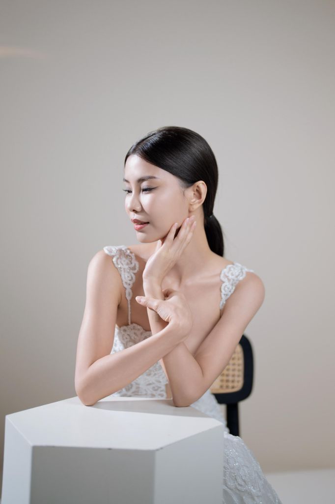 Serene bridal portrait with soft natural makeup, eyes closed